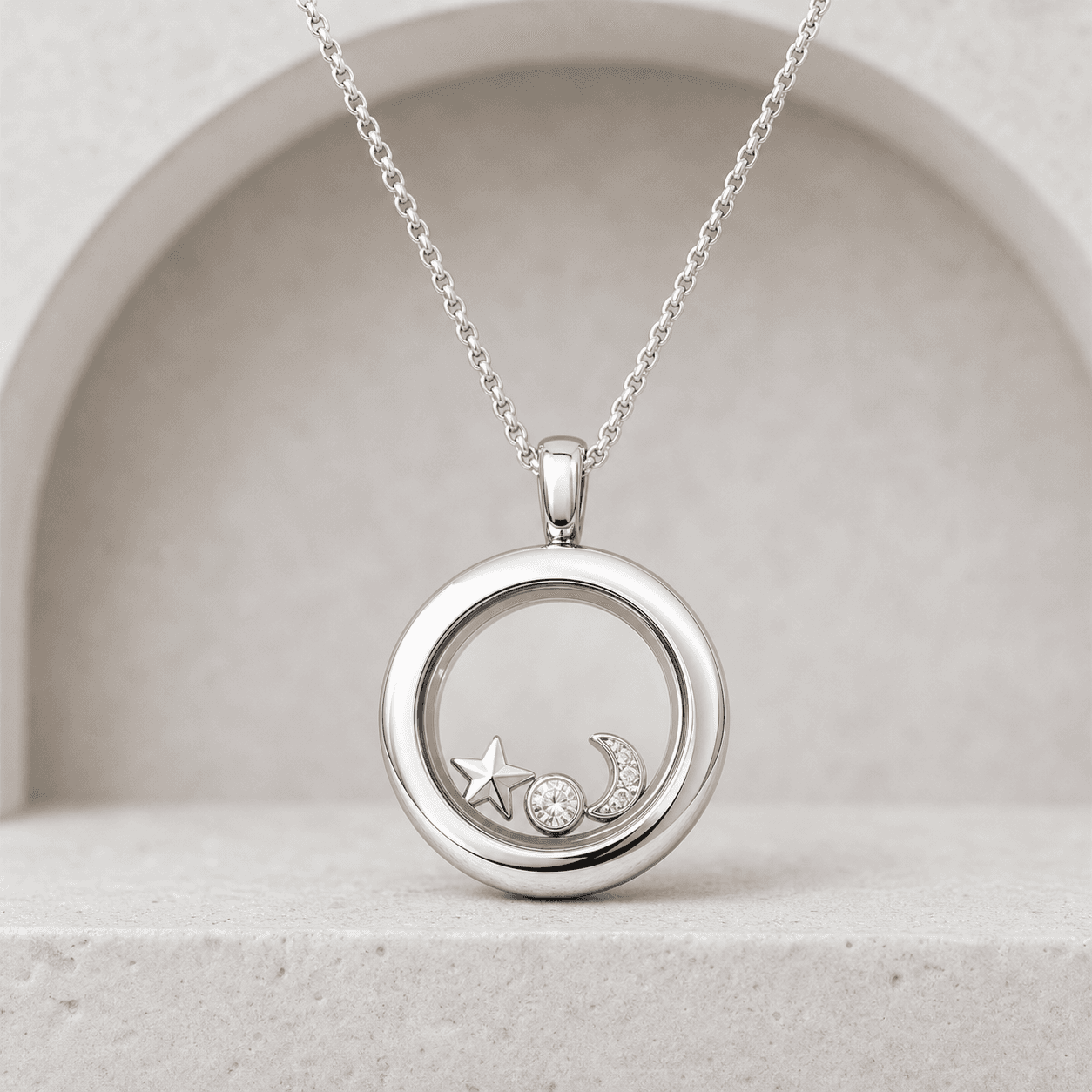 Silver round living locket with star, moon, and crystal charms
